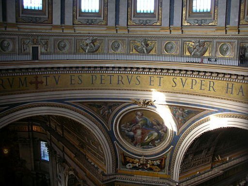 A photo of the Latin phrase "Tu es Petrus" inscribed in the St. Peter's rotunda.